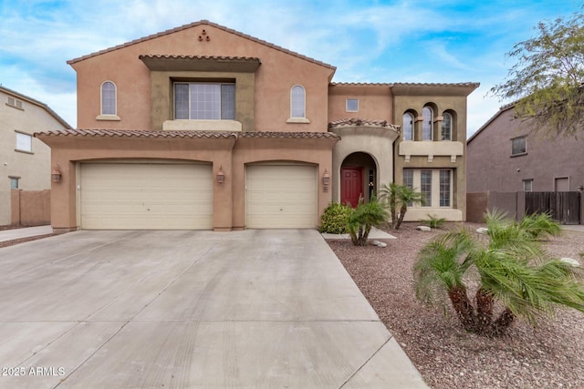 mediterranean / spanish-style house with fence, driveway, stucco siding, a garage, and a tile roof