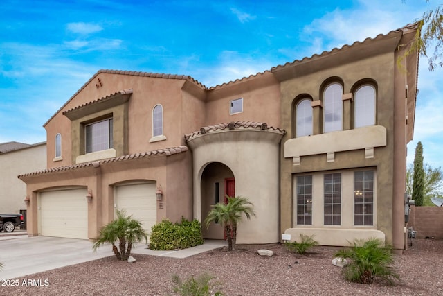 mediterranean / spanish-style home featuring concrete driveway, an attached garage, and stucco siding