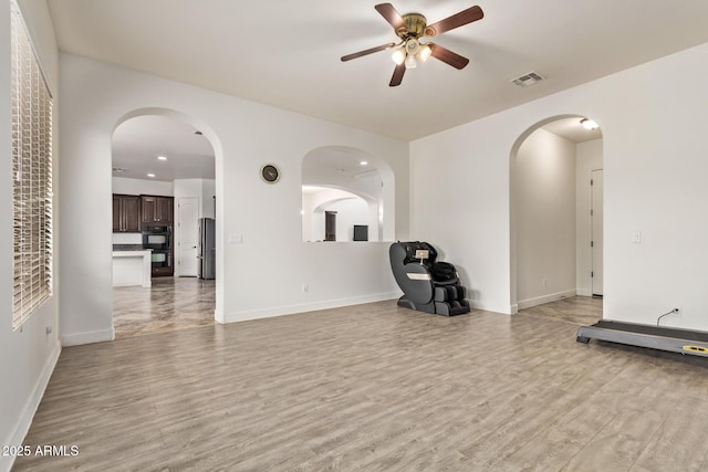 unfurnished living room with visible vents, light wood finished floors, and ceiling fan