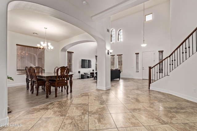 dining space with visible vents, baseboards, a notable chandelier, and light tile patterned flooring