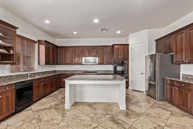 kitchen with visible vents, recessed lighting, stone countertops, a sink, and black appliances