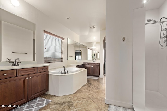 full bath featuring a bath, visible vents, walk in shower, and a sink