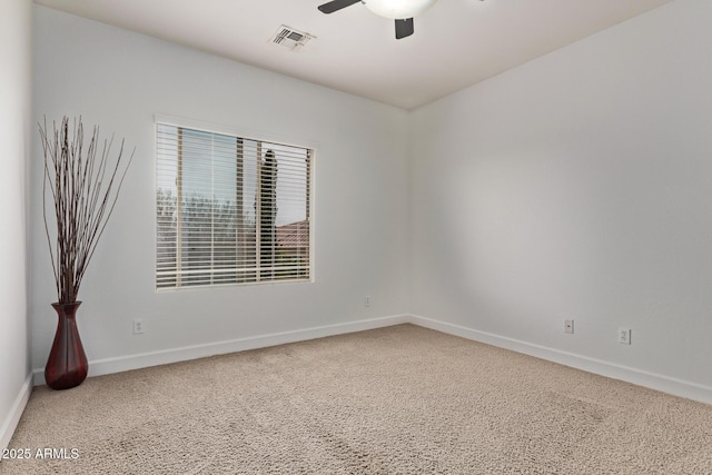 spare room featuring visible vents, baseboards, and ceiling fan