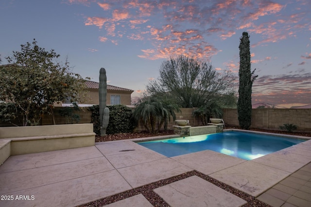 view of swimming pool featuring a fenced backyard, a fenced in pool, and a patio