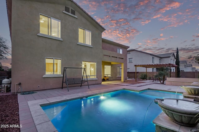 pool at dusk featuring a fenced in pool, fence, a patio area, and a pergola