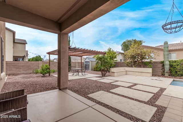 view of patio with an outdoor structure, a fenced backyard, a pergola, and a shed