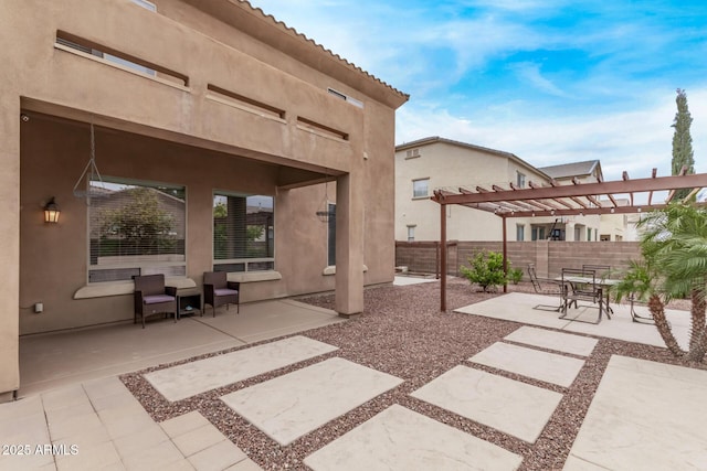 view of patio with a pergola and fence