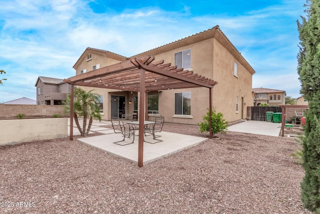 back of house with a patio area, a fenced backyard, and stucco siding