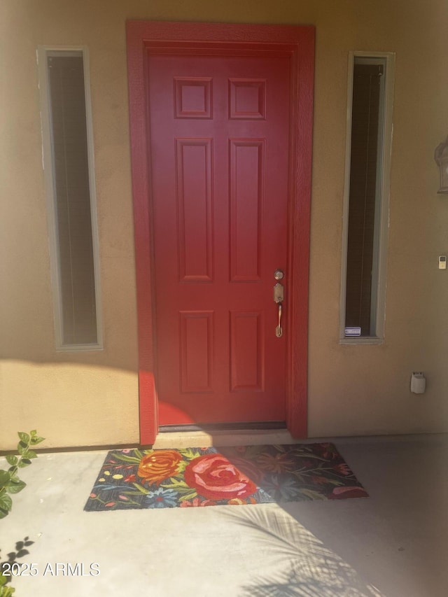 property entrance featuring stucco siding