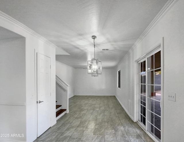 interior space featuring crown molding and a notable chandelier