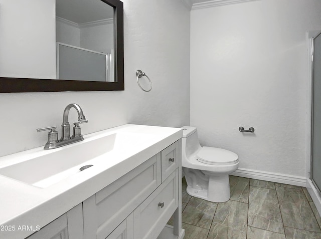 bathroom featuring vanity, crown molding, a shower with shower door, and toilet