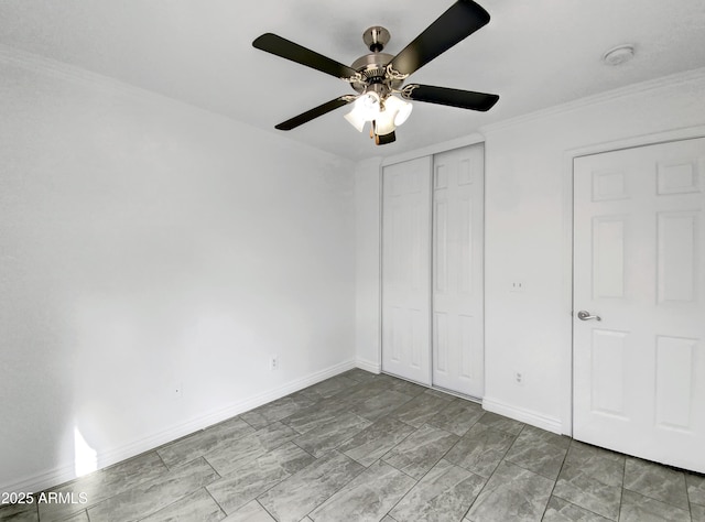 unfurnished bedroom featuring crown molding, a closet, and ceiling fan