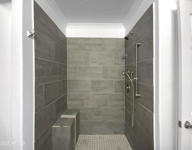 bathroom featuring ornamental molding and a tile shower