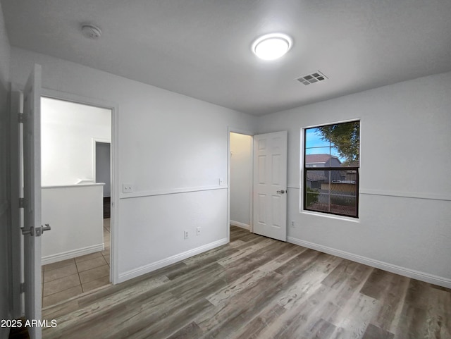 empty room with wood-type flooring