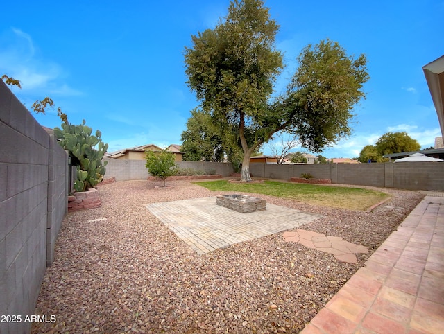 view of yard with a patio and a fire pit