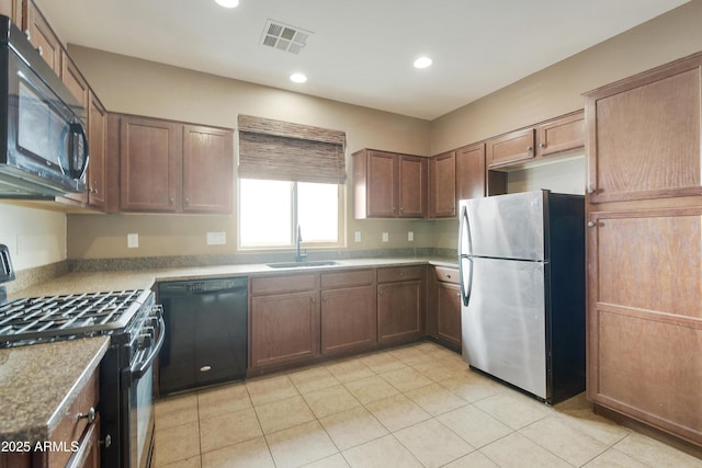 kitchen featuring a sink, black appliances, light tile patterned flooring, visible vents, and recessed lighting