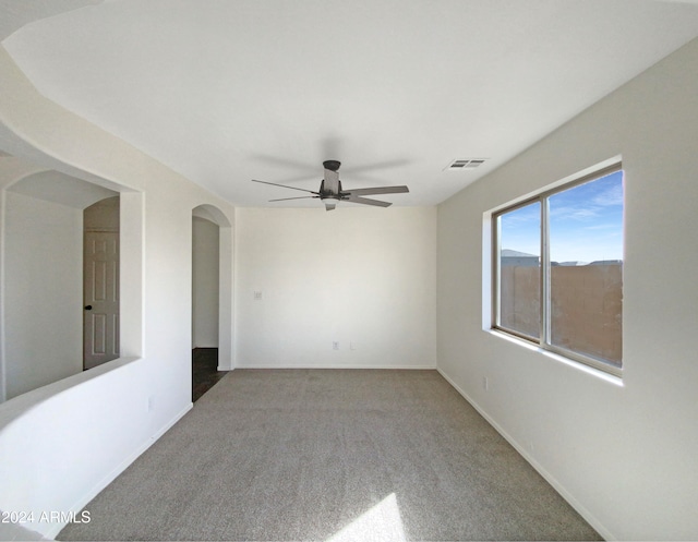 carpeted spare room with ceiling fan