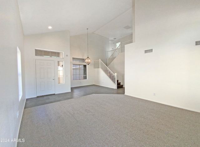 entryway with a chandelier and high vaulted ceiling