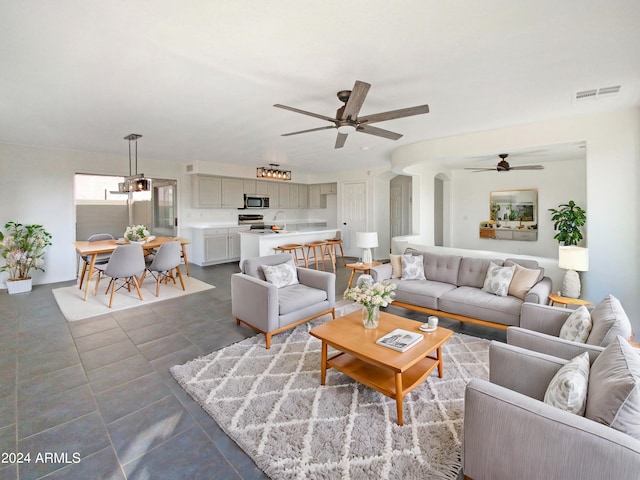 living room featuring sink and ceiling fan