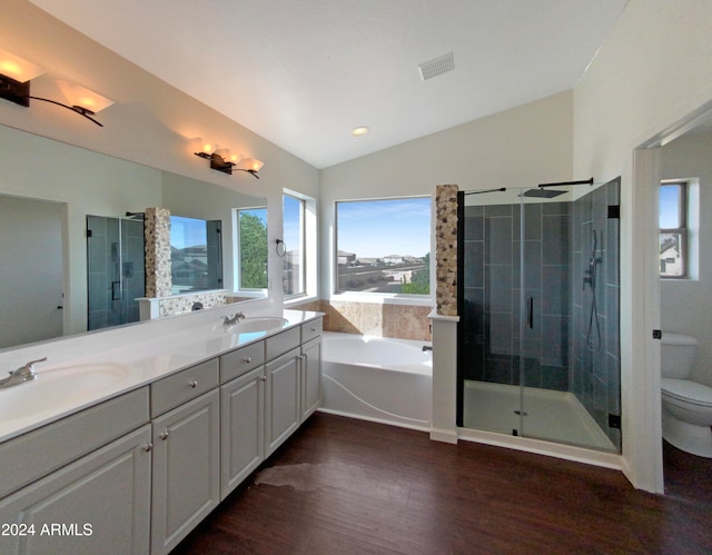 full bathroom with plus walk in shower, toilet, vaulted ceiling, vanity, and hardwood / wood-style flooring