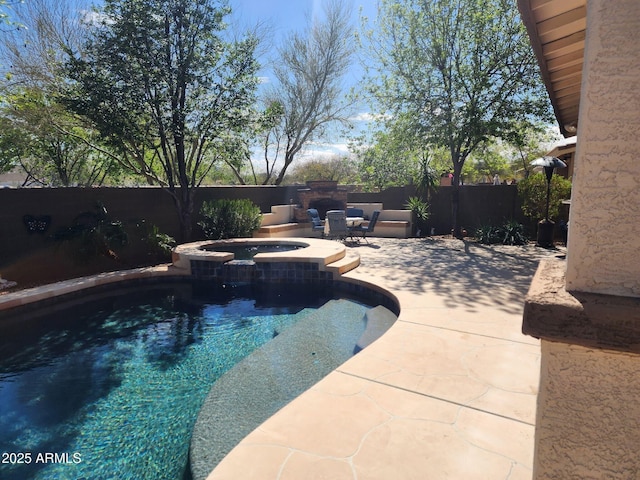 view of swimming pool featuring a pool with connected hot tub, a fenced backyard, and a patio area