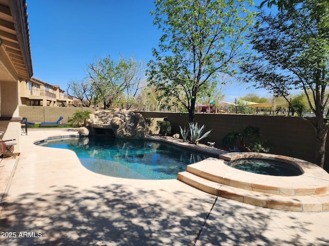 view of pool with an in ground hot tub, a fenced in pool, a patio, and a fenced backyard