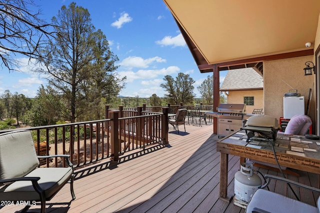 wooden deck with a grill