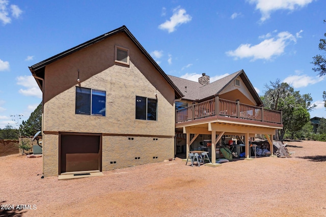 back of house with a deck