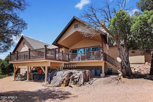 rear view of property with a wooden deck