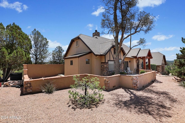 view of side of home featuring an outdoor kitchen