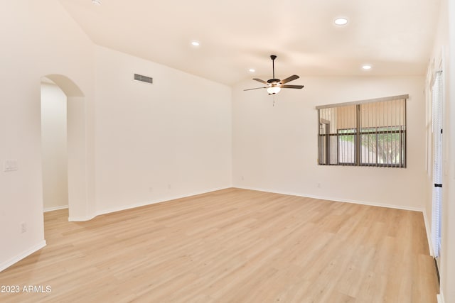 unfurnished room featuring ceiling fan, vaulted ceiling, and light hardwood / wood-style floors