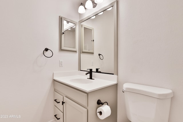 bathroom featuring toilet and vanity