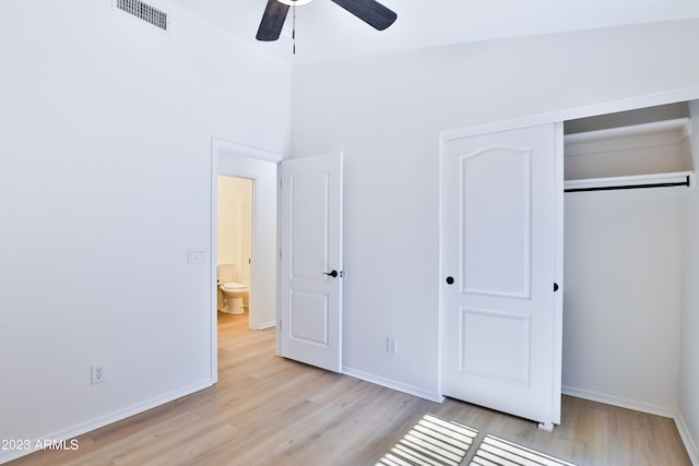 unfurnished bedroom featuring ceiling fan, a closet, and light hardwood / wood-style flooring