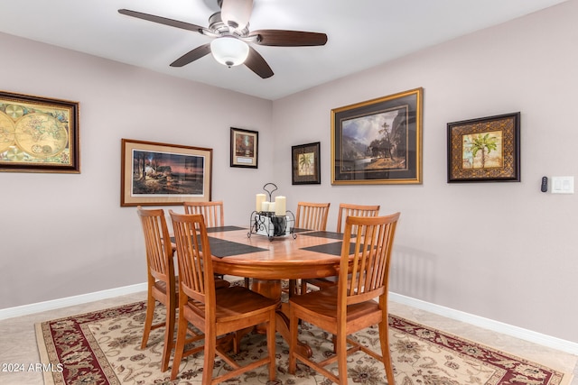 tiled dining space featuring ceiling fan