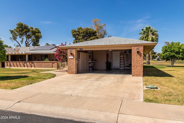 view of front facade featuring a front yard and a carport