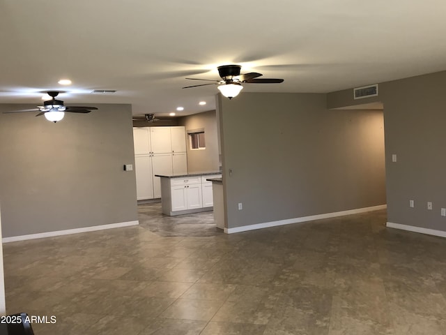 unfurnished living room featuring ceiling fan