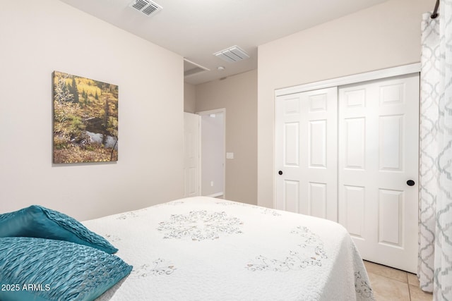 bedroom featuring light tile patterned flooring and a closet