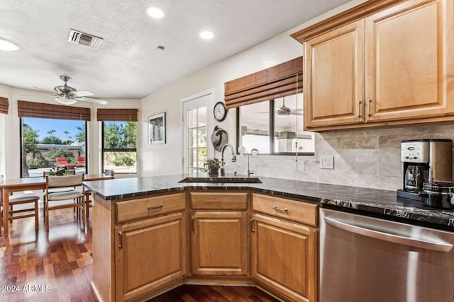 kitchen featuring ceiling fan, dark hardwood / wood-style flooring, a textured ceiling, stainless steel dishwasher, and sink