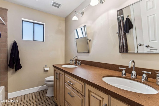 bathroom featuring toilet, a bathing tub, vanity, and tile patterned flooring