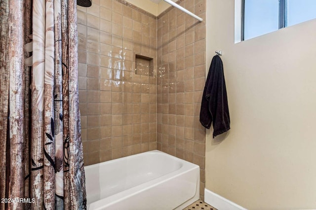 bathroom with shower / bath combination with curtain and tile patterned flooring