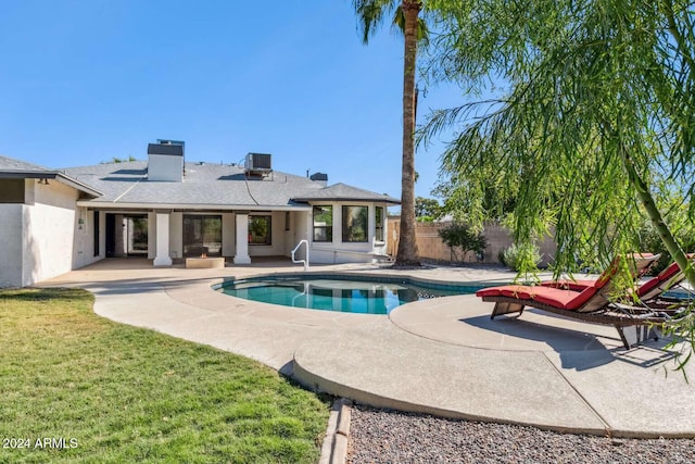 view of pool with a patio area, central AC, and a lawn