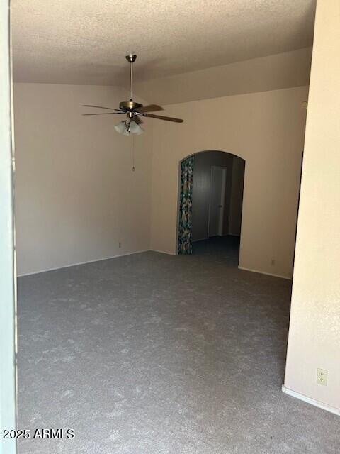 15088 N 85th Dr, Peoria, AZ 85381 - unfurnished room featuring ceiling fan, arched walkways, a textured ceiling, and lofted ceiling