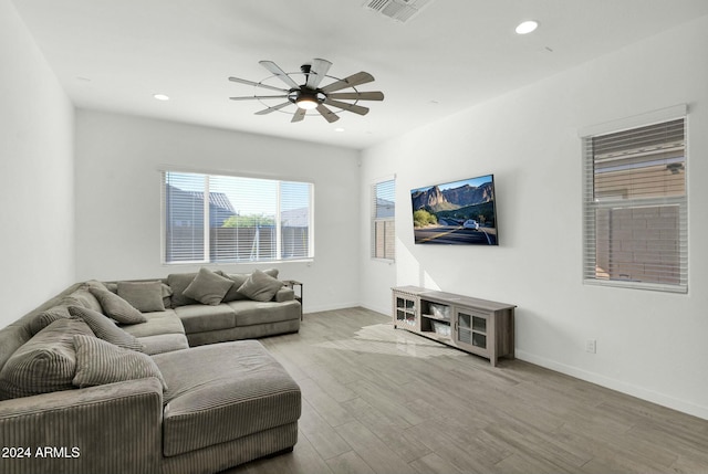 living room featuring hardwood / wood-style floors and ceiling fan