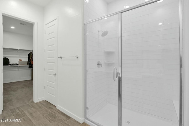 bathroom with a shower with shower door