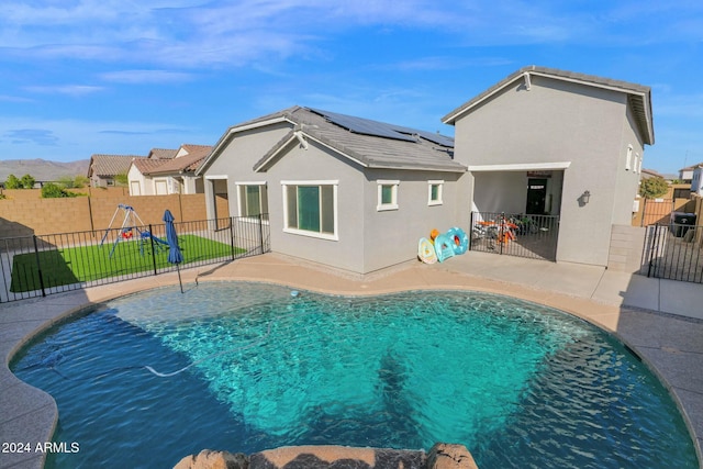 view of pool featuring a patio and a playground