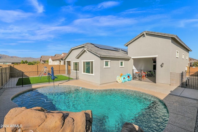 view of swimming pool with a mountain view and a patio