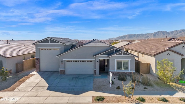 view of front facade featuring a mountain view and a garage