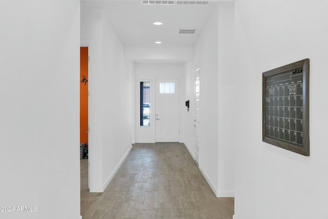 corridor with light hardwood / wood-style floors