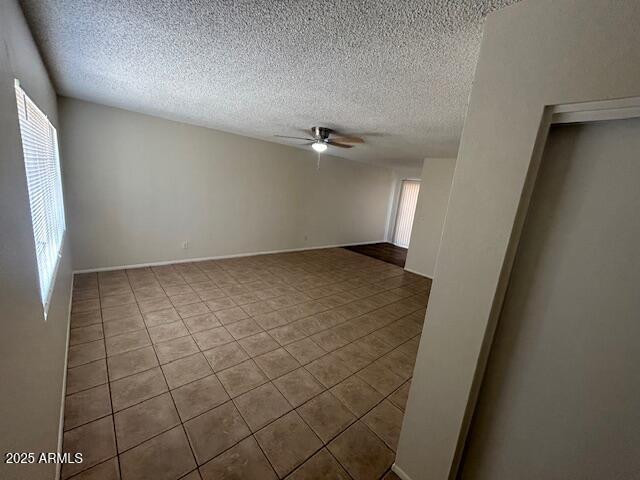 4625 W Thomas Rd Unit 48, Phoenix, AZ 85031 - empty room featuring ceiling fan, tile patterned floors, and a textured ceiling