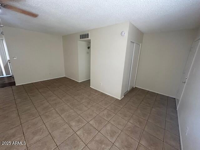 4625 W Thomas Rd Unit 48, Phoenix, AZ 85031 - empty room with a textured ceiling, a ceiling fan, light tile patterned floors, and a smoke detector